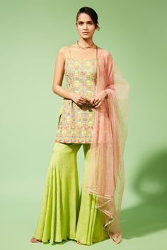 Green kurta with multicolor thread and mirror work embroidered pattern. Paired with flared hem sharara pants. Comes with sheer dupatta with bead tassels at hem.
Component: 3
Pattern: Embroidered
Type Of Work: Thread, Mirror work
Neckline: Square neck
Sleeve Type: Sleeveless
Fabric: Palazzo: Georgette, Kurta: Silk, Dupatta: Tulle
Color: Green,Pink
Other Details: 
Gathered detailing
Bead tasseled dupatta hem
Occasion: Mehendi and Haldi - Aza Fashions Palazzo Kurta, Gharara Pants, Georgette Kurta, Sharara Pants, Flared Palazzo, Short Kurta, Daily Paper, Sharara Set, Thread Embroidery