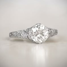 an antique style diamond ring with filigrees