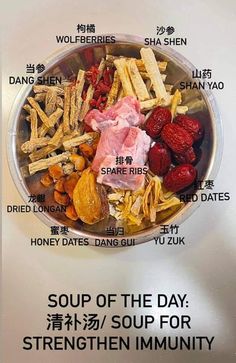 a bowl filled with different types of food on top of a white countertop next to a sign that says soup of the day