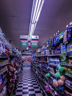 a grocery store filled with lots of food and drink bottles on shelves next to each other