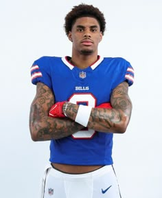 a football player with tattoos on his arms