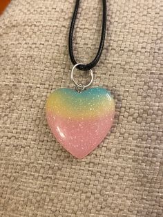 "This super cute, medium sized multi colored resin heart pendant is absolutely stunning. The pendant looks fantastic from every angle. It is strung along a 20-22\" length black cord. This can be placed on 18-20\" black cord if requested for no additional charge. This is an absolutely gorgeous pendant and would be a great birthday present, anniversary present, Mother's Day gift, Christmas present, or graduation gift. The sleek design of this pendant will turn heads and make you take a second look! (Hand strung item) Like what you see? View more at: https://www.etsy.com/shop/StephsCraftingBits" Trendy Heart Beads Necklace For Gifts, Multicolor Heart Jewelry For Friendship, Cute Double Heart Jewelry With Heart Print, Fun Heart Beads Jewelry As Gift, Cute Heart Pendant Jewelry For Friendship, Cute Heart Pendant Necklace With Heart Beads, Cute Multicolor Jewelry With Heart Charm, Fun Colorful Necklaces For Gifts, Handmade Multicolor Jewelry For Valentine's Day