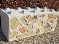 a cement block with several small rocks on it's sides and one is made out of concrete