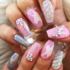 pink and silver nails with white glitters, bows and pearls on the tip of each nail