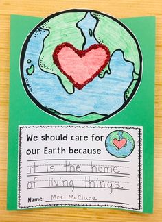 the earth with a heart on it is shown in this handmade card for children