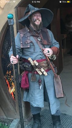 a man dressed in pirate costume standing next to a door