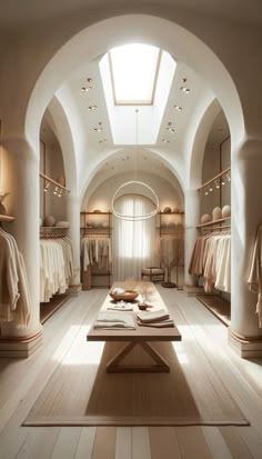 the interior of a clothing store with lots of clothes on display and an arched ceiling