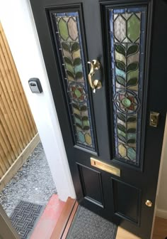 a black door with stained glass panels on it