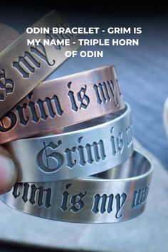 a person holding three different metal bracelets with words on them and an inscription that says, my name is triple horn