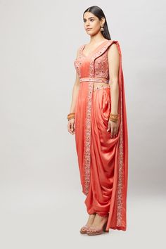 Modern, fun and chic! This readymade coral dhoti saree with multi-resham embroidery is perfect for any bridal event! Fabric: Satin silk Ready to Ship Occasion: Sangeet, Mehendi Events WASH CARE INSTRUCTIONS - Please Dry clean only when it is applicable. Slight color variation is possible due to digital photography. Jewelry not included Silk Draped Traditional Wear, Traditional Silk Draped Wear, Draped Art Silk Sets With Dupatta, Draped Art Silk Lehenga With Resham Embroidery, Bollywood Style Draped Lehenga With Resham Embroidery, Festive Draped Lehenga With Resham Embroidery, Traditional Draped Sharara For Reception, Traditional Unstitched Draped Sets, Festive Draped Resham Embroidery Lehenga