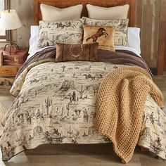 a bed with pillows and blankets on top of it next to a wooden headboard