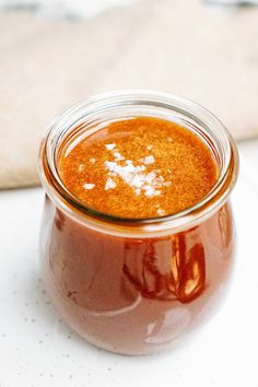 a glass jar filled with liquid sitting on top of a table