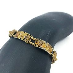 Vintage gold tone filigree bracelet, This lovely bracelet consists of eight beautiful rectangular filigree panels each with a repousse floral detail. It has a spring-ring clasp. Unlike anything made today! A great piece for gifting! CONDITION Good vintage condition. DIMENSIONS 7″ x 1/4″ Jewelry comes in a box ready for gift-giving Questions for me? Scroll down and click Message Tracey, I will get back to you typically within a few minutes. Ready to buy? Click Add to Cart and pay with Pay Pal or credit card. Satisfaction is guaranteed. Your vintage treasure will be carefully packaged and on it's way to you typically within 24 hours. Need something for your home? Visit www.vivaterravintage.etsy.com for a selection of vintage lovelies for the home. Antique Gold Rectangular Bracelet, Vintage Gold Bracelets With Intricate Design, Gold Metal Bracelets With Intricate Design, Antique Etched Gold Bracelets, Antique Etched Gold Bracelet, Vintage Gold Etched Bracelet, Ornate Antique Gold Bracelets As Gift, Ornate Antique Gold Bracelet As Gift, Ornate Antique Gold Bracelet For Gifts