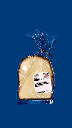 a piece of bread wrapped in plastic on top of a blue surface with a tag attached to it