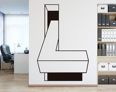 a black and white wall decal in an office with bookshelves on the shelves