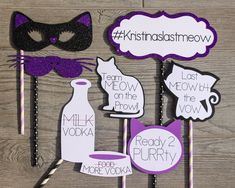 purple and black photo booth props with cat masks on them for masqueradee