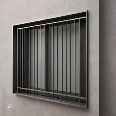 a window with bars on the side of it in front of a concrete wall,