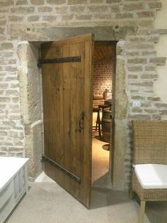 an open wooden door in a stone walled room