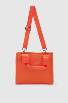 Introducing the "Canvas Fabric Orange Crossbody Bag" from Lunarity Garage – a vibrant and stylish accessory that combines the durability of canvas fabric with a pop of orange color. Crafted with meticulous attention to detail, this bag offers both fashion and functionality to suit your everyday needs. Make a bold statement with the Canvas Fabric Orange Crossbody Bag – a perfect blend of durability and trendiness. The vibrant orange color adds a touch of energy and excitement, making it a versati Trendy Orange Shoulder Bag For School, Orange Pouch Shoulder Bag For School, Orange Crossbody School Bag, Orange Crossbody Bag For School, School-ready Orange Pouch Shoulder Bag, Large Capacity Orange Shoulder Bag For School, Casual Orange Shoulder Bag With Double Handle, Large Capacity Orange Pouch Shoulder Bag, Orange Box Bag With Large Capacity For Daily Use