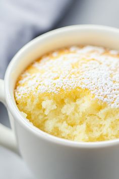 a close up of a cup of food with powdered sugar on top and in the middle