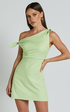 Get ready to turn heads in the Jeofina Mini Dress! This one-shoulder tie dress in a gorgeous celery shade is perfect for any party day or night. Made from a blend of cotton and rayon, this A-line dress is not only stylish but also comfortable to wear. The one-shoulder design adds a touch of sophistication, while the mini length shows off your legs. Whether you're hitting the club or attending a summer soirée, this dress will make you feel confident and empowered. Stand out from the crowd and sho Green Off Shoulder Mini Dress For Spring, Green Mini-length Off-shoulder Dress For Spring, Green Mini Dress With Straight Neckline For Brunch, One Shoulder Sleeveless Dress For Garden Party, Sleeveless One Shoulder Dress For Garden Party, Fitted One Shoulder Dress For Summer Garden Party, Summer Garden Party Fitted One Shoulder Dress, Green One-shoulder Dress For Brunch, Summer Cocktail One Shoulder Dress With Straight Neckline