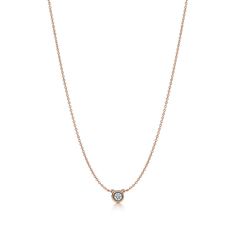 A single hand-polished diamond shines at the center of this delicate and refined 18k rose gold pendant. Elsa Peretti’s revolutionary Diamonds by the Yard® collection features a combination of fine, fluid chains and bezel-set stones that forever changed the role of diamonds in fashion. Suspended like a single drop of light against the skin, layer this design with other Diamonds by the Yard® pendants and necklaces of varying lengths and metals for a look that’s all your own. 18k rose gold with a bezel-set round brilliant diamond; On a 16" cable chain; Spring clasp closure; Carat weight .14; Original designs copyrighted by the Nando and Elsa Peretti Foundation | Elsa Peretti® Diamonds by the Yard® Single Diamond Pendant in Rose Gold, Size: .14 Tiffany Necklace Diamond, Unicorn Aesthetic, Diamonds By The Yard Necklace, Diamonds By The Yard, Romantic Gift Ideas, Jewellery Bracelets, Tiffany Necklace, Tiffany Jewelry, Elsa Peretti