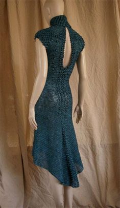 a mannequin wearing a blue dress with crocheted details on the back