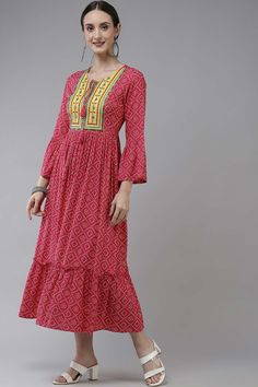 Pink Bandhni print woven A line dress, has a Tie Up Neck, three-quarter Bell Sleeves ,embroidery Work Yuke,layered Dress Full on closure, and flared hem Comes Size & Fit Regular fit Material & Care Rayon Hand-wash Product Features: Top Color: Pink Top Fabric: Viscose Rayon Work: embroidery Pattern: bandhani Print Neck: Tie-up neck Sleeve Length: Three-quarter sleeves Kurta Shap: A-Line Top Length: Calf length Occasion: Festive Product type: Dress Disclaimer: There will be slight difference in di Pink Bottom, Layer Dress, Embroidery Dress, Top Fabric, Quarter Sleeve, Three Quarter Sleeves, Xl Dress, Pink Tops, Dresses Online