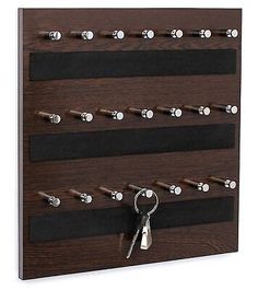 a wooden key holder with keys hanging on it