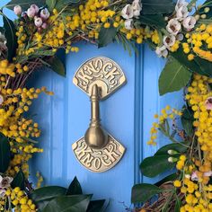 a blue door with yellow flowers and a wreath on it