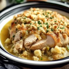 a close up of a plate of food with meat and stuffing on it, sitting on a table