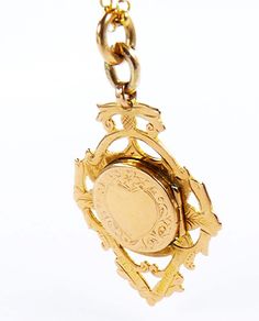 An outstanding fully hallmarked gold watch fob locket which is an ideal unisex gift, whether it is suspended from a fob chain or necklace. This antique keepsake fob locket was assayed* (tested for gold purity*) at Birmingham in 1907. The anterior surface is fitted with a locket compartment which is ornamented with a heart shaped cartouche framed by acanthus leaves and a single forget-me-not flower. This keepsake pendant is suspended from a beautiful 18 inch 9 carat gold belcher chain necklace. Gold Medallion Pocket Watch For Wedding, Heirloom Yellow Gold Pocket Watch For Anniversary, Vintage Medallion Pocket Watch For Wedding, Vintage Medallion Pocket Watch For Weddings, Heirloom Locket Jewelry For Commemoration, Gold Engraved Medallion Pocket Watch, Antique Locket Jewelry For Commemoration, Engraved Medallion Pocket Watch For Wedding, Antique Locket For Commemoration