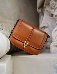 Brown Calf Leather Shoulder Bag With Brass Hardware, Timeless Rectangular Flap Bag With Gold-tone Hardware, Timeless Cognac Bag With Brass Hardware, Timeless Cognac Bags With Brass Hardware, Cognac Rectangular Bag With Turn-lock Closure, Luxury Cognac Satchel With Brass Hardware, Formal Tan Shoulder Box Bag, Timeless Crossbody Shoulder Bag, Classic Tan Box Bag With Top Handle