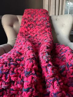 a crocheted blanket sitting on top of a couch