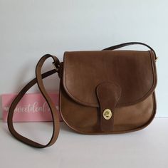 "Vtg classic coach Saddlery Bag Soft and supple British Tan leather with brass hardware Roomy interior with zip pocket, outer slip pocket covered by a flap and secured with a turnlock. Adjustable strap with a 14 1/2\"-21\" drop Measures: 9 1/2\"L, 9\"H, 4\"W Made in New York City, USA #922-6736 Flaws: faint stains on top of bag that did not remove with a deep cleaning. Cleaned, conditioned and ready to wear! More vtg coach styles/colors available Questions? Just ask G80" Coach Saddle Bag, Vintage Coach Bags, Bag Obsession, Leather Coach, Purses Designer, Coach Bag, Coach Leather, Saddle Bag, Vintage Coach