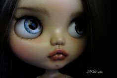 an image of a doll with big blue eyes