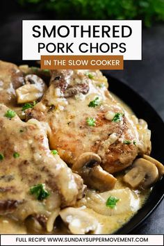 a black plate topped with meat covered in mushroom gravy next to parsley