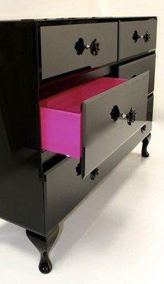 an image of a dresser with drawers painted black and pink on the bottom, but not in color