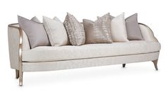 a white couch with many pillows on it's back and sides, sitting against a white background