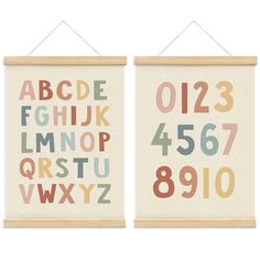 two wall hangings with letters and numbers on them, one is white and the other is multicolored