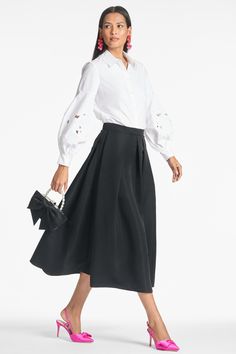 There are few things that are as perennial as the "Party" skirt. The tea-length box pleat event skirt can easily be worn 12 months out of the year. It can be paired with the coordinating bralette tops, or as an item it can easily go back to a crisp with a crisp white blouse or black turtleneck. *THERE IS NO STRETCH IN THE WAIST, YOU MAY CONSIDER SIZING ONE SIZE UP. Details: Model is 5'11" Wearing A Size 2 35.5" Long Back Zipper Poly Faille 100% Polyester Imported Style #S221S01-001 Basic Blouse, Crisp White Blouse, Box Pleat Skirt, Basic Blouses, Split Skirt, Party Skirt, Black Turtleneck, Bralette Tops, Princess Seams