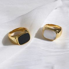 This 18K Gold Plated Mother-of-Pearl Ring is a luxurious, statement-making piece. Featuring a chunky gold band with both mother-of-pearl and black onyx accents, it's the perfect unique gift for any special occasion. This signet ring is also an ideal stacking ring for daily wear. [MATERIAL]: Yellow brass with real 18k gold plated. Our ring will not tarnish or turn green.[WHITE SHELL SIZE]: [1.5cm Wide]: 1.5*1.1cm or 0.6”*0.43” [1.2cm Wide]: 1.2*1.0cm or 0.47”*0.39” Woman Rings, Ring Party Jewelry, Trendy Rings, Urban Jewelry, 7 Jewelry, 2 Rings, Shell Ring, 6 Rings, Chunky Rings