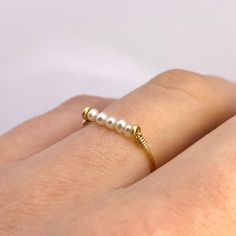 This beautifully simple ring is lovingly handmade with 5 tiny Freshwater Pearls and a choice of 14k Gold Filled, 14k Rose Gold Filled or Sterling Silver band. M A T E R I A L S: * Freshwater Pearl * 14k Gold Filled, 14k Rose Gold Filled or Sterling Silver S I Z E: *  Gemstone - Approximately 2mm each *  Band Thickness - Approximately 0.8-1mm  All of our jewellery is carefully handmade using good quality materials and handpicked gemstones, with the aim to produce quality pieces that you can love 14k Gold Filled Stackable Rings As Gift, Dainty Handmade Midi Rings For Anniversary, Simple Design Gold Stackable Rings As Gift, Dainty Pearl Ring With Simple Design For Gift, Dainty Pearl Ring With Simple Design, Dainty Handmade Stackable Rings For Anniversary, Dainty Pearl Ring With Simple Design As A Gift, Handmade Dainty 14k Gold Midi Rings, Minimalist Handmade Pearl Ring For Anniversary