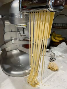 the pasta is being made by an electric hand mixer with nozzles on it