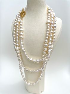 This luxurious necklace features two hundred hand-strung freshwater pearls with a beautiful lustre, meticulously crafted on a 100% silk threader and finished with an exquisite, secure gold OT clasp. A truly unique design allows for multiple ways of wearing the necklace, including three layers, two layers, twisted as a single layer, or any other creative arrangement that suits your personal style. This versatility ensures that you can effortlessly adapt the necklace to complement various outfits Elegant Baroque Pearl Lariat Necklace, Luxury Double Strand Pearl Necklace, Luxury Multi-strand Pearl Chain Necklace, Luxury Multi-strand Pearl Necklace For Wedding, Luxury Lariat Pearl Necklace With Pendant, Luxury Multi-strand Pearl Jewelry, Luxury Long Pearl Necklace For Wedding, Elegant Hand Knotted Lariat Jewelry, Luxury Long Pearl Necklace With Charm