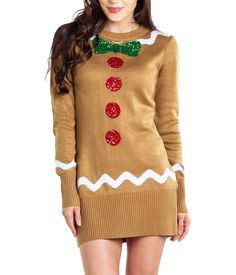 a woman in a sweater dress with a bow tie and christmas decorations on her neck