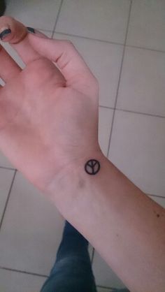 a person with a small tattoo on their wrist