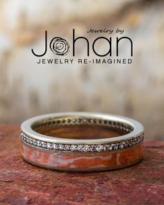 a wedding band made out of wood and diamonds on top of a stone slab with the words johan jewelry re - imagined