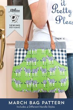 a woman holding a green and white bag with zebras on it in front of a pink door