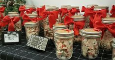 there are many mason jars with red bows on them